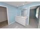 Bathroom featuring a double sink vanity and neutral tile flooring at 8009 Sail Clover Ln, Zephyrhills, FL 33540