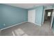 Neutral bedroom with carpet, a double closet and access to other rooms at 8009 Sail Clover Ln, Zephyrhills, FL 33540