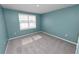 Comfortable bedroom with neutral carpet flooring and a window with blinds at 8009 Sail Clover Ln, Zephyrhills, FL 33540