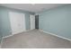 Comfortable bedroom featuring carpet flooring and an attached closet at 8009 Sail Clover Ln, Zephyrhills, FL 33540