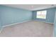 Bright bonus room with a window, neutral walls, and carpet flooring at 8009 Sail Clover Ln, Zephyrhills, FL 33540
