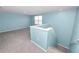 Spacious bonus room at the top of the stairs with natural light at 8009 Sail Clover Ln, Zephyrhills, FL 33540
