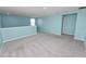 Bright, open bonus room with carpet, leading to a doorway at 8009 Sail Clover Ln, Zephyrhills, FL 33540