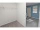 Walk-in closet with wire shelving and neutral carpet flooring at 8009 Sail Clover Ln, Zephyrhills, FL 33540