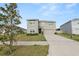Two-story house with a driveway and a green lawn, with mature landscaping at 8009 Sail Clover Ln, Zephyrhills, FL 33540
