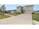 Front exterior of two-story home with attached two-car garage at 8009 Sail Clover Ln, Zephyrhills, FL 33540