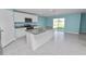 Modern kitchen with granite countertops, stainless steel appliances, and a spacious island at 8009 Sail Clover Ln, Zephyrhills, FL 33540