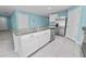 Well-equipped kitchen featuring an island, granite countertops, and stainless steel appliances at 8009 Sail Clover Ln, Zephyrhills, FL 33540