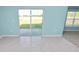 Bright living room with sliding glass doors and views of the fenced backyard at 8009 Sail Clover Ln, Zephyrhills, FL 33540