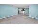 Open-concept living room flows into a bright kitchen with modern appliances at 8009 Sail Clover Ln, Zephyrhills, FL 33540