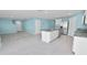 Open concept living room and kitchen with stainless appliances and granite countertops at 8009 Sail Clover Ln, Zephyrhills, FL 33540
