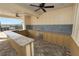 Covered outdoor kitchen area with granite countertops, stainless steel sink, and scenic views at 8009 Sail Clover Ln, Zephyrhills, FL 33540
