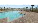 Community pool featuring an inviting pool with comfortable lounge chairs and lake views at 8009 Sail Clover Ln, Zephyrhills, FL 33540