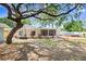 Backyard featuring above ground pool, screened porch, outbuilding, and landscaped yard at 1411 Fernwood Pl, Seffner, FL 33584