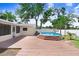 A backyard with a wooden deck and an above-ground pool surrounded by a privacy fence at 1411 Fernwood Pl, Seffner, FL 33584