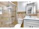 Stylish bathroom with tiled shower, modern fixtures, and contemporary vanity with storage at 1411 Fernwood Pl, Seffner, FL 33584