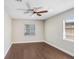 Bedroom with wood floors, two windows, and a ceiling fan at 1411 Fernwood Pl, Seffner, FL 33584
