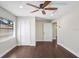 Bedroom features wood floors, bright lighting, and double door closet at 1411 Fernwood Pl, Seffner, FL 33584