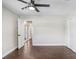 Well-lit bedroom featuring hardwood floors, a ceiling fan, and ample closet space at 1411 Fernwood Pl, Seffner, FL 33584