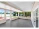 Enclosed patio featuring tile flooring, neutral walls, and multiple windows at 1411 Fernwood Pl, Seffner, FL 33584
