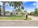Charming single-story home featuring a well-manicured lawn, attractive landscaping, and brick facade at 1411 Fernwood Pl, Seffner, FL 33584
