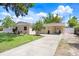Charming single-story home featuring a well-manicured lawn and an extra long driveway at 1411 Fernwood Pl, Seffner, FL 33584