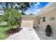 Close-up of a charming single-story home with a brick facade and small, well-kept lawn at 1411 Fernwood Pl, Seffner, FL 33584