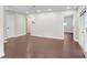 Spacious living room featuring hardwood floors and neutral paint, perfect for entertaining and relaxing at 1411 Fernwood Pl, Seffner, FL 33584