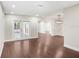 Spacious living room featuring hardwood floors, white walls, and a modern light fixture at 1411 Fernwood Pl, Seffner, FL 33584