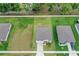 An aerial view showing a neighborhood, with similar rooflines, green lawns, and clear street layout at 203 Lovely Ct, Plant City, FL 33566