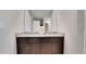 Well-lit bathroom with a double sink vanity, granite countertop, and modern fixtures at 203 Lovely Ct, Plant City, FL 33566