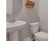 Clean bathroom with a pedestal sink, round mirror, and toilet with white paint and simple decor at 203 Lovely Ct, Plant City, FL 33566