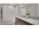 Bright bathroom featuring a dual sink vanity with granite countertops and a tiled shower and tub combination at 203 Lovely Ct, Plant City, FL 33566