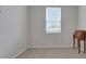 Sunlit bedroom with neutral paint and soft carpeting, enhanced by a classic writing desk and bright window at 203 Lovely Ct, Plant City, FL 33566
