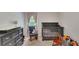 Charming Bedroom with a comfortable rocking chair, crib, and dresser for a peaceful start at 203 Lovely Ct, Plant City, FL 33566