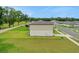 An exterior view of a two-story home showcasing the side of the property and a green lawn at 203 Lovely Ct, Plant City, FL 33566