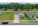 A stunning two-story home with neutral siding, blue shutters, and a manicured front yard with mature landscaping at 203 Lovely Ct, Plant City, FL 33566