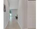 Well-lit hallway featuring neutral paint, tile flooring, and convenient closet space at 203 Lovely Ct, Plant City, FL 33566