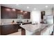 Spacious kitchen with stainless steel appliances, dark cabinetry, and a large island with seating at 203 Lovely Ct, Plant City, FL 33566
