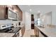 Modern kitchen featuring stainless steel appliances, granite countertops, and dark wood cabinetry at 203 Lovely Ct, Plant City, FL 33566