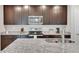 Well-equipped kitchen featuring granite countertops, stainless steel appliances, and dark cabinetry at 203 Lovely Ct, Plant City, FL 33566
