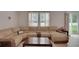 Relaxing living room features a plush sectional sofa, a coffee table, and views of the backyard at 203 Lovely Ct, Plant City, FL 33566