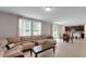 Open living space connects kitchen & living room, featuring a large sectional sofa and natural light at 203 Lovely Ct, Plant City, FL 33566