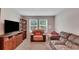 Inviting living room with comfortable seating, entertainment center, and natural light from bright windows at 203 Lovely Ct, Plant City, FL 33566