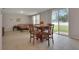 Bright living space with a round dining table, comfortable seating, and a large slider door to the outside at 203 Lovely Ct, Plant City, FL 33566