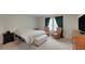 Inviting bedroom with natural light, seating area, and dresser creates a relaxing retreat at 203 Lovely Ct, Plant City, FL 33566