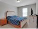 Cozy bedroom featuring a plush bed, neutral tones, and ample natural light from a window at 203 Lovely Ct, Plant City, FL 33566