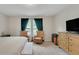 Inviting bedroom with natural light, comfortable seating, and dresser creates a relaxing retreat at 203 Lovely Ct, Plant City, FL 33566