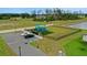 A community playground featuring colorful play structures, surrounded by lush landscaping, seating, and accessible parking at 203 Lovely Ct, Plant City, FL 33566