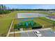 A fully equipped playground near a tranquil pond, offering diverse recreational activities in a community setting at 203 Lovely Ct, Plant City, FL 33566